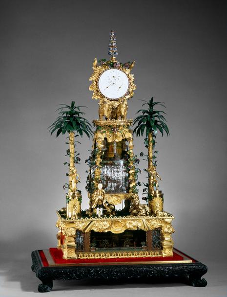 铜镀金人戏狮象驮钟