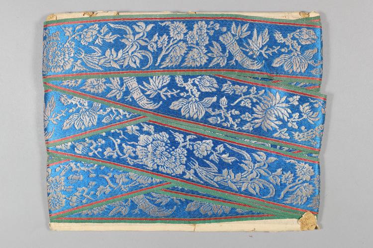 品蓝色缎地织银梅兰竹菊牡丹纹绦