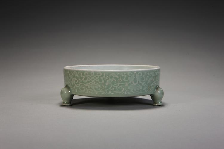 雍正款冬青釉暗划缠枝八吉祥纹三足盘